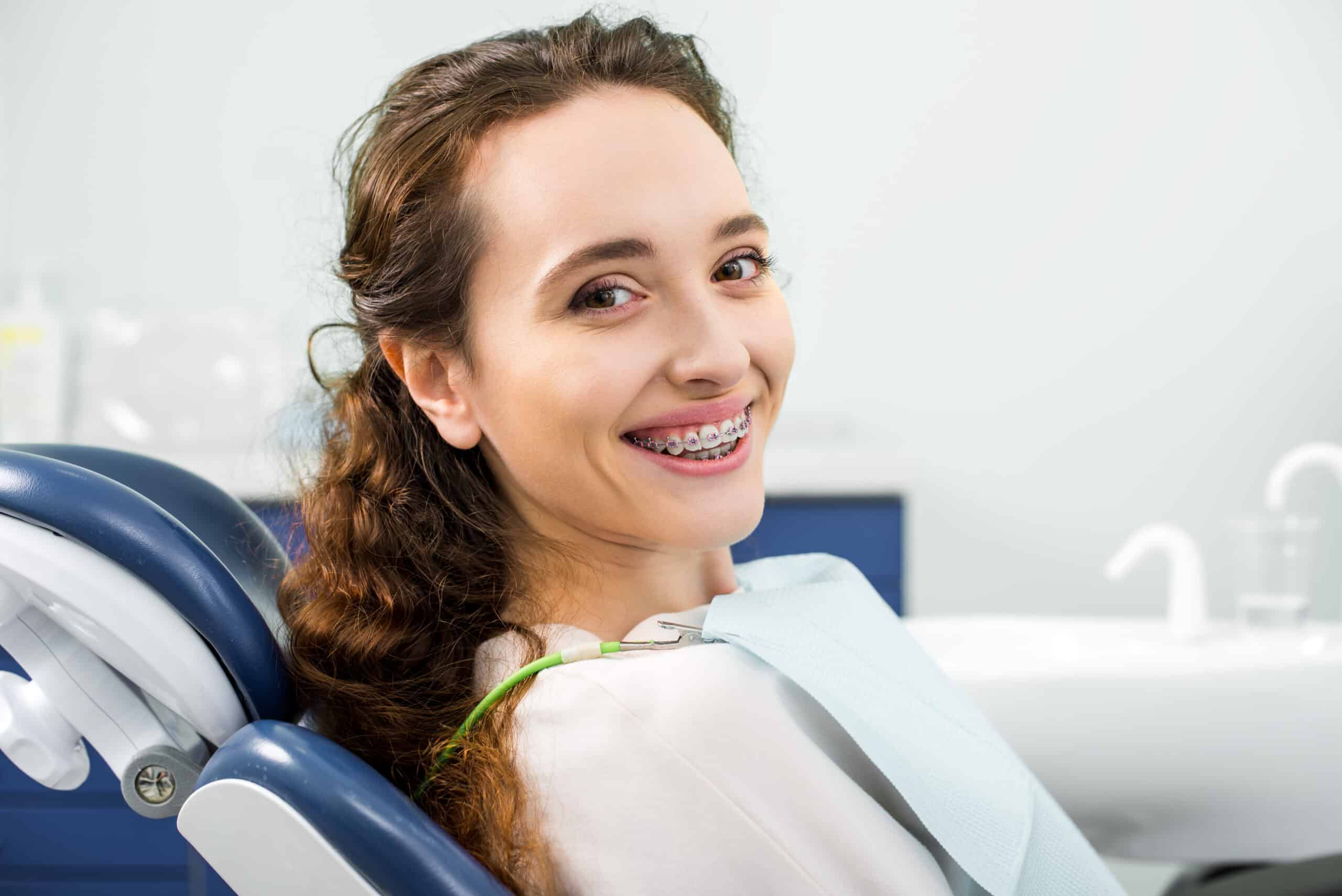Happy,Woman,In,Braces,Smiling,During,Examination,In,Dental,Clinic
