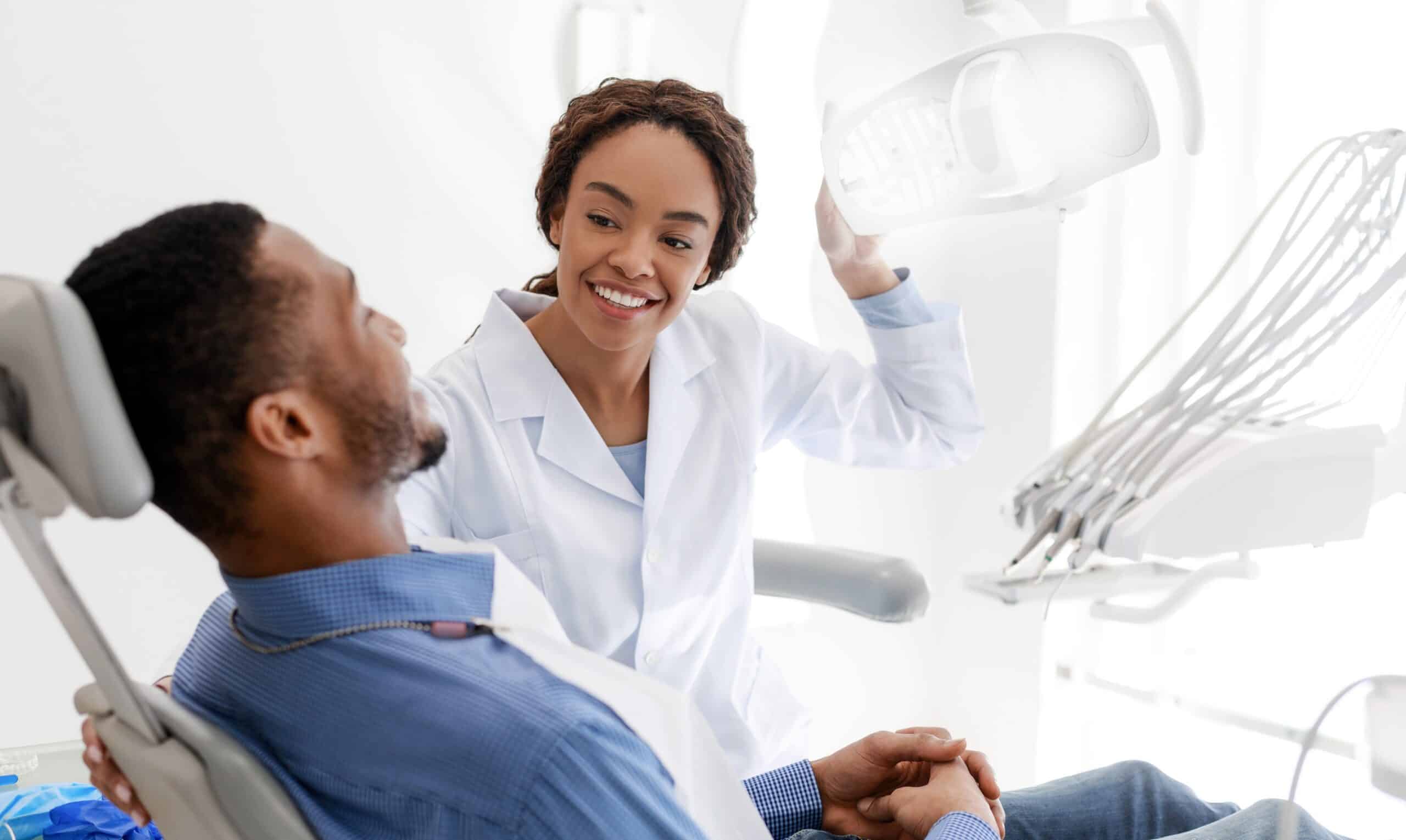 African,Female,Dentist,Turning,On,Lamp,Before,Treatment,,Smiling,To