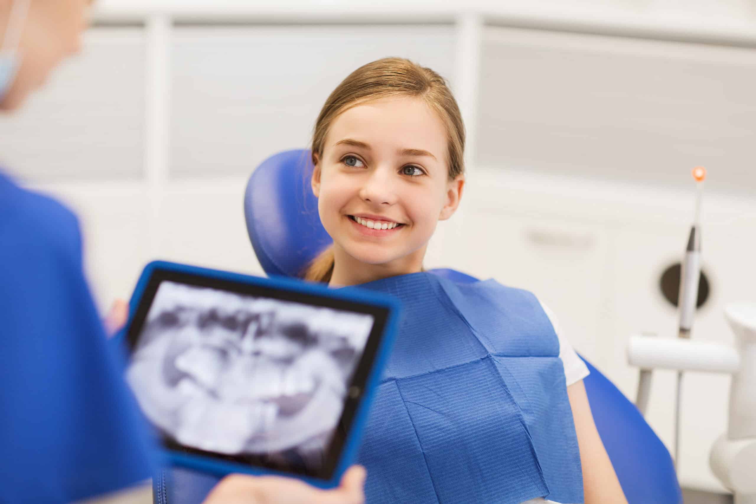 Dentist,With,X-ray,On,Tablet,Pc,And,Girl,Patient